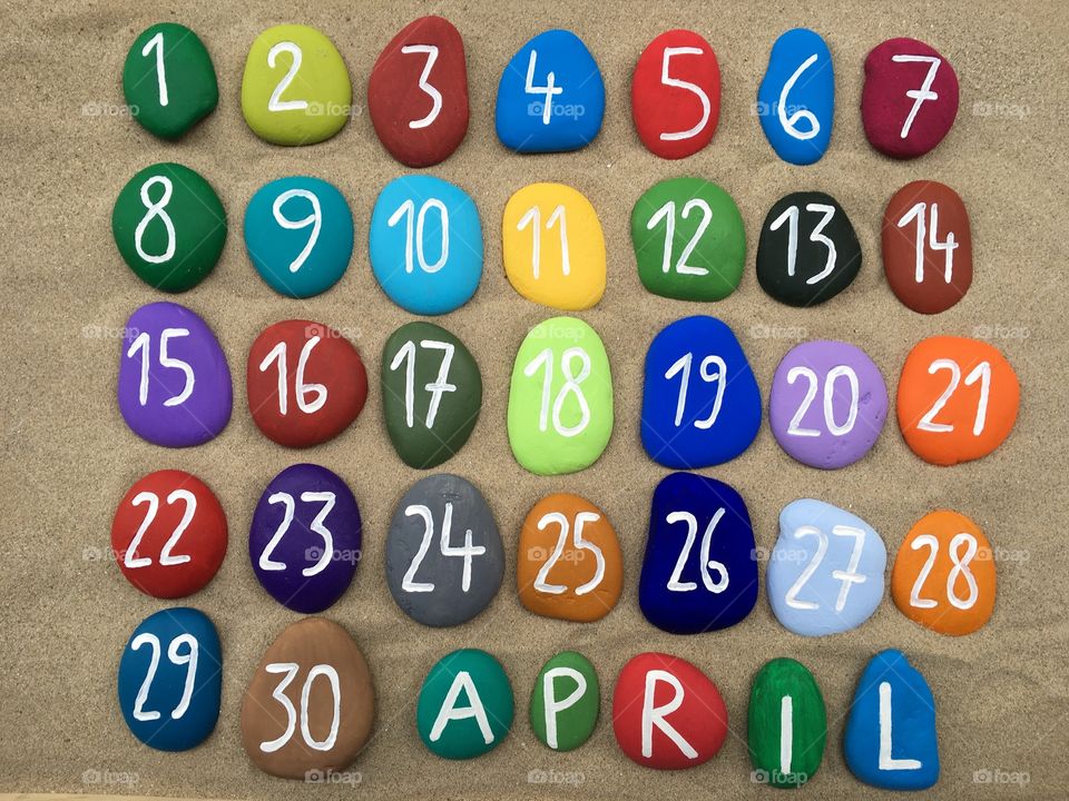 April, calendar on colored stones 