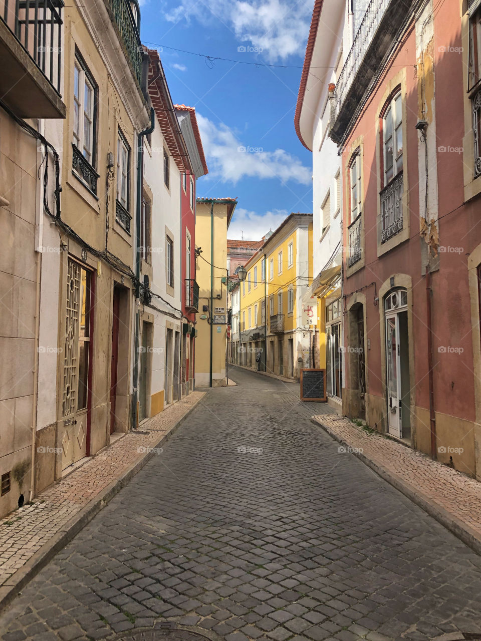 A lone person in the normally busy streets in the old town area of the city of Tomar, Portugal. At the start of Covid-19 outbreak in March 2020