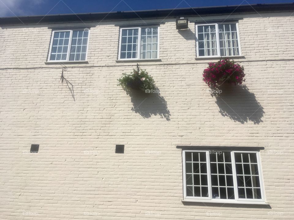 Side view of offices with hanging baskets in North Watford, Hertfordshire