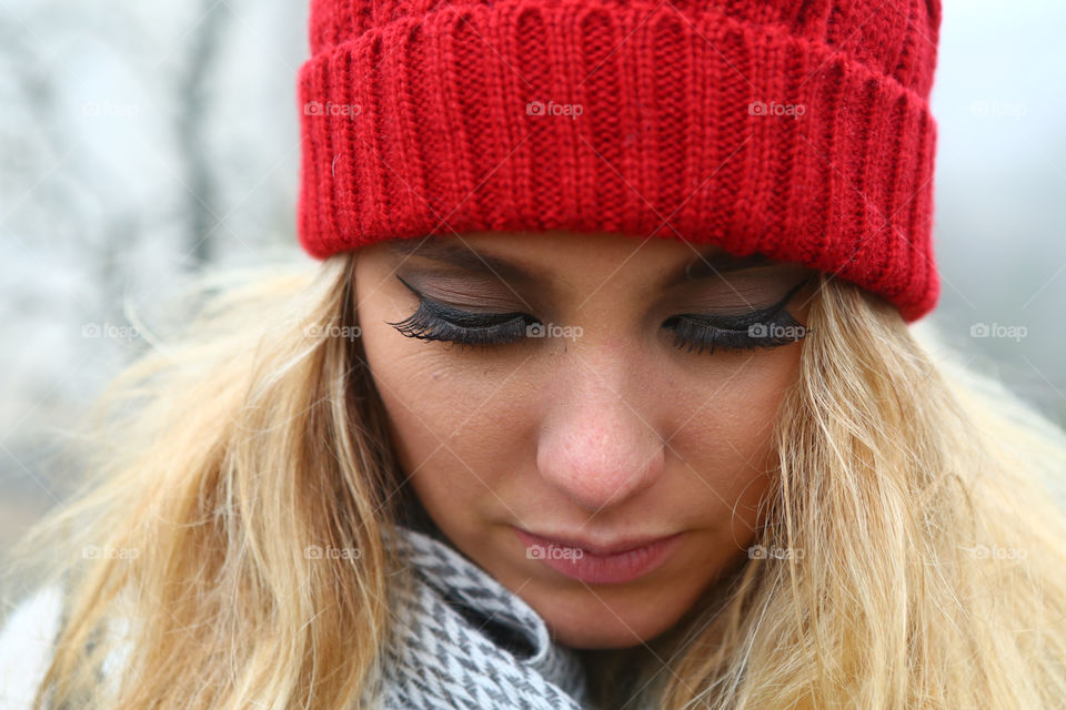 Close-up of a young woman with red woolly hat