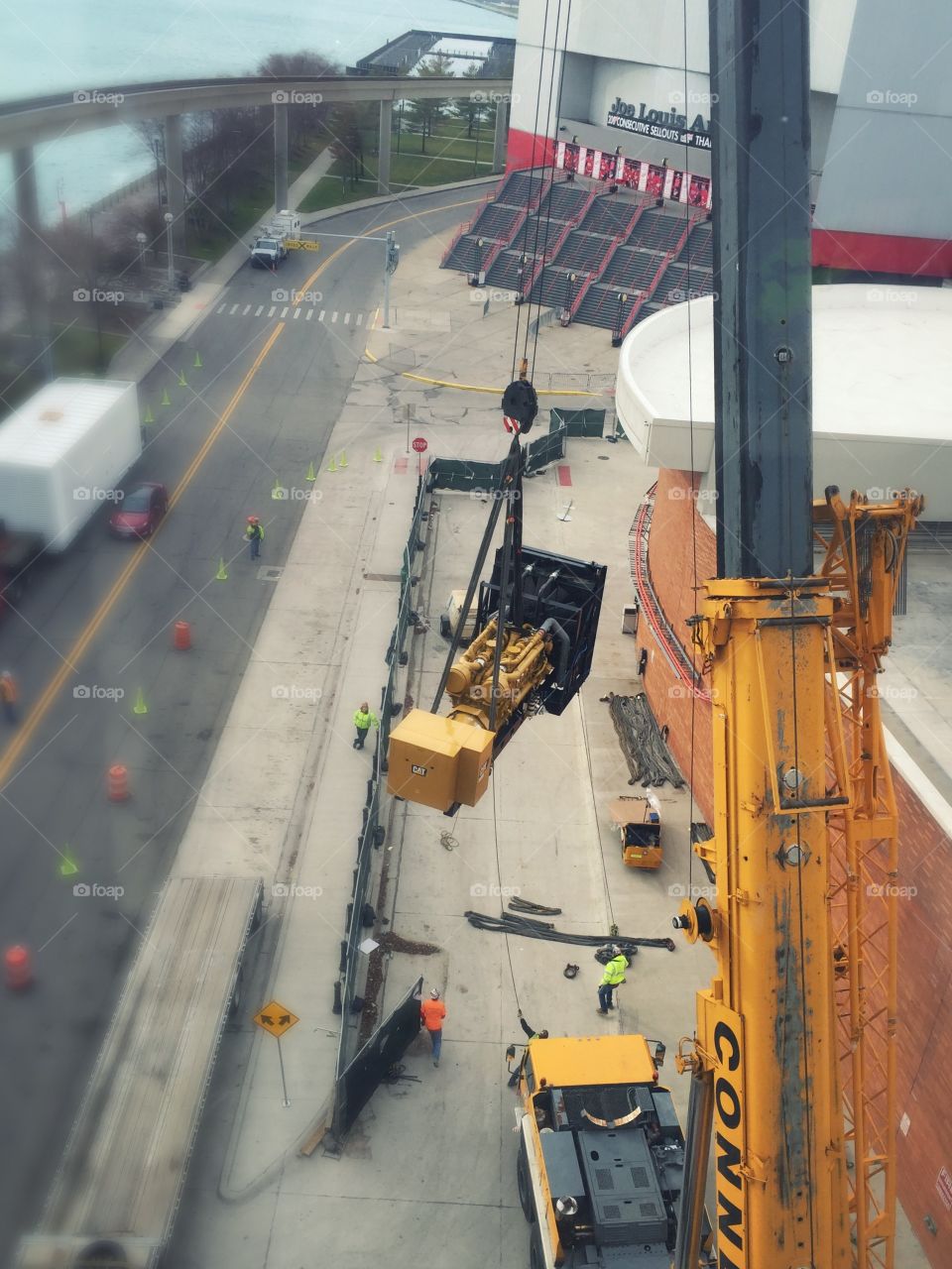 Construction site in Detroit! Moving a generator onto the roof of a building. 