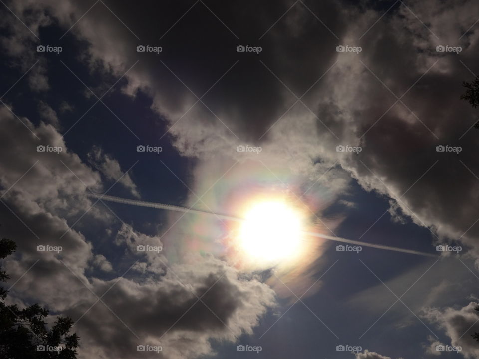 sun and clouds. Trace left by plane on a beautiful sky crossing the amazing Sun