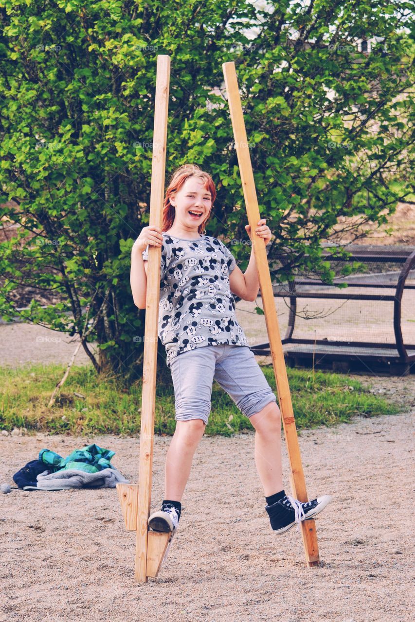 Girl on stilts