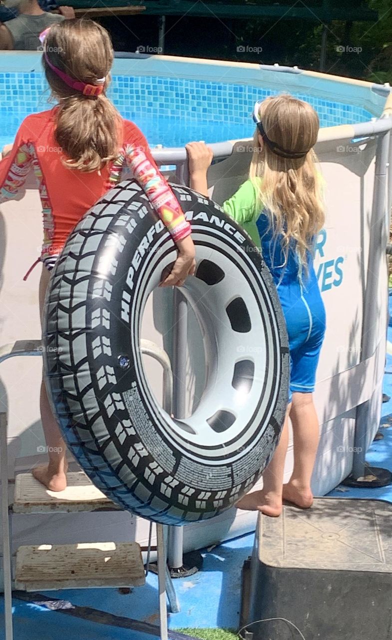 Two kids waiting to get in the pool