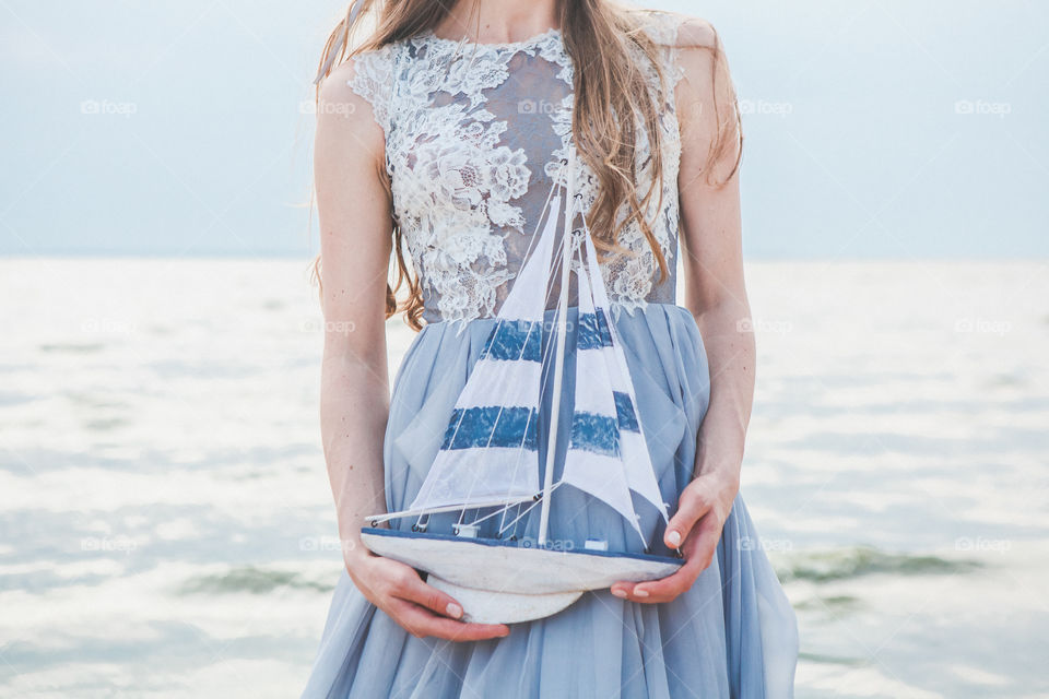 toy boat in bride's hands