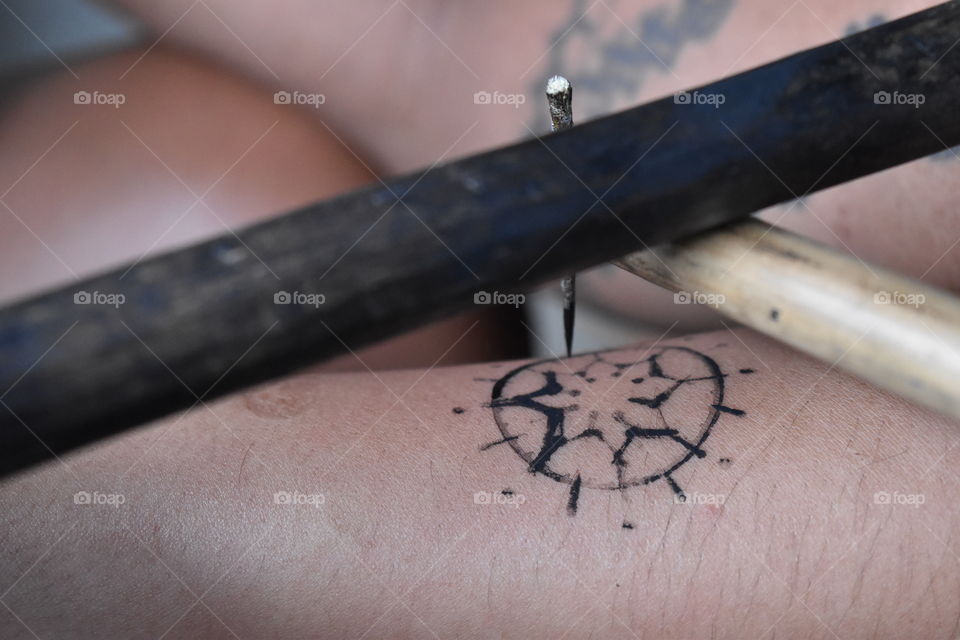 Traditional Hand Tap tattoo 