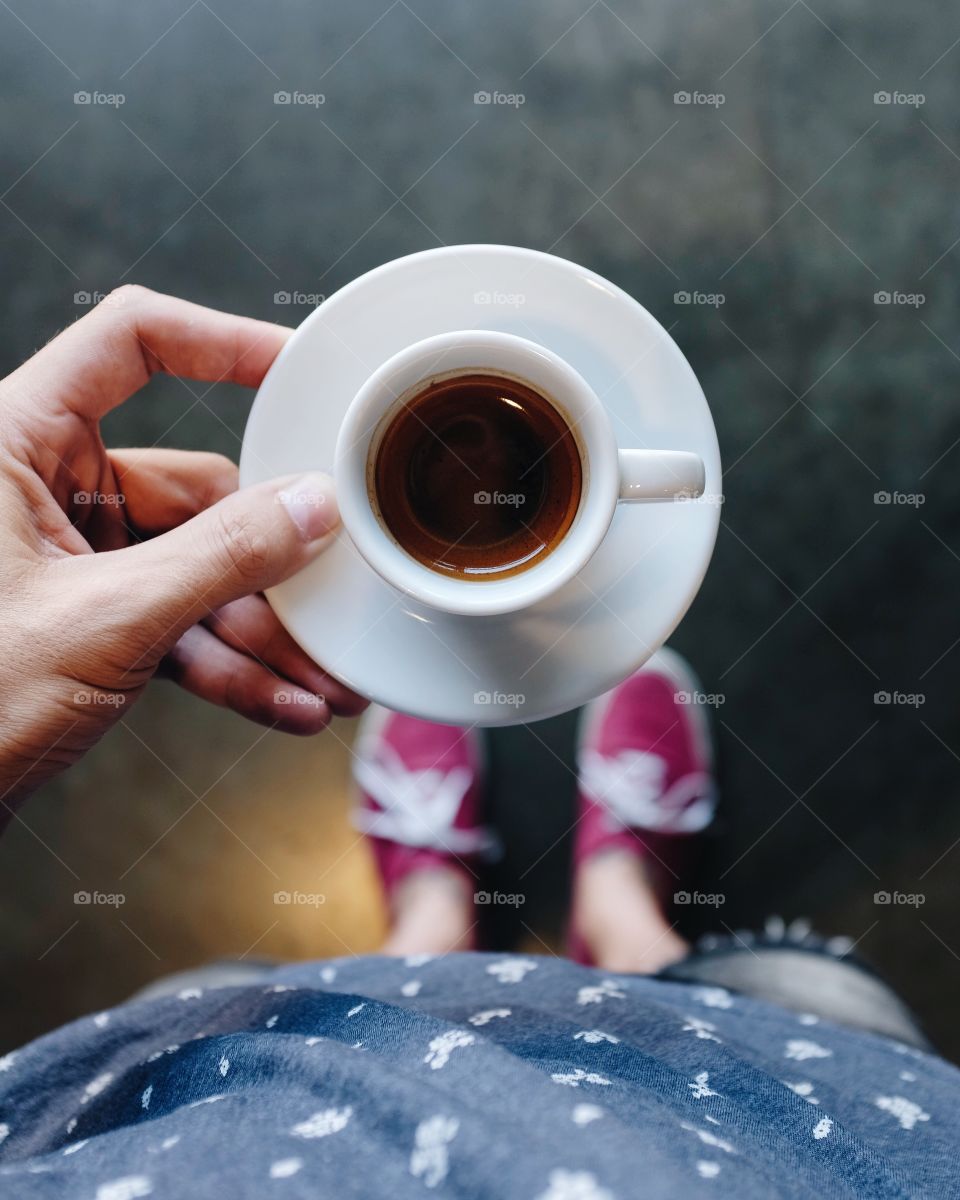 Person's hand holding coffee mug