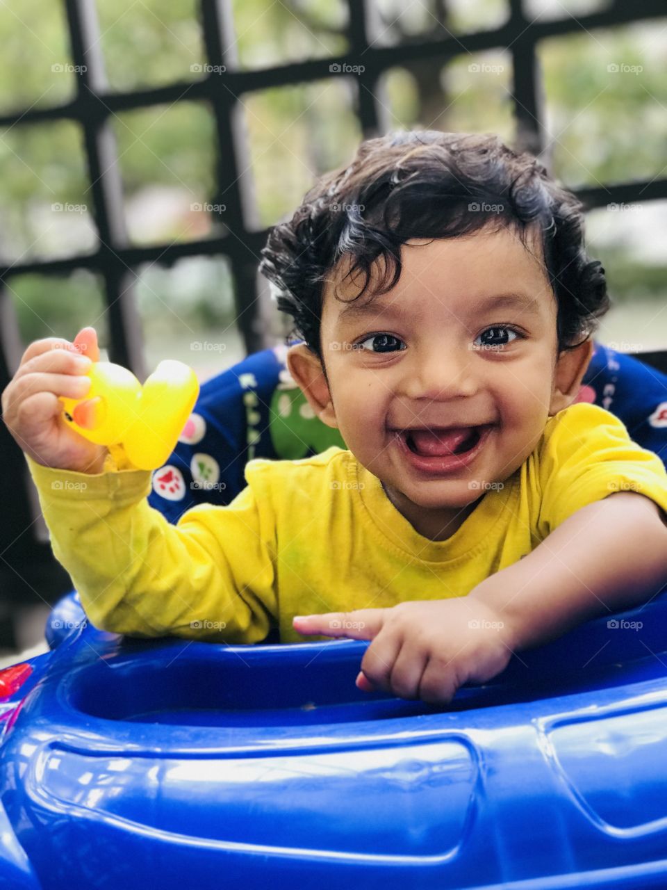 Cute boy smile,baby boy wearing yellow shirt and with yellow duck