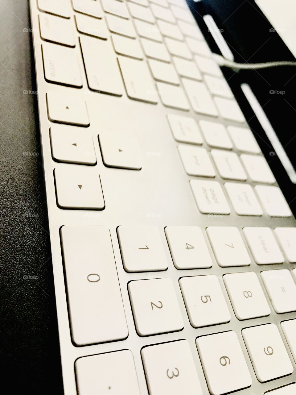 Fun angle for photographing this sleek white Apple keyboard on ultra black desk! 