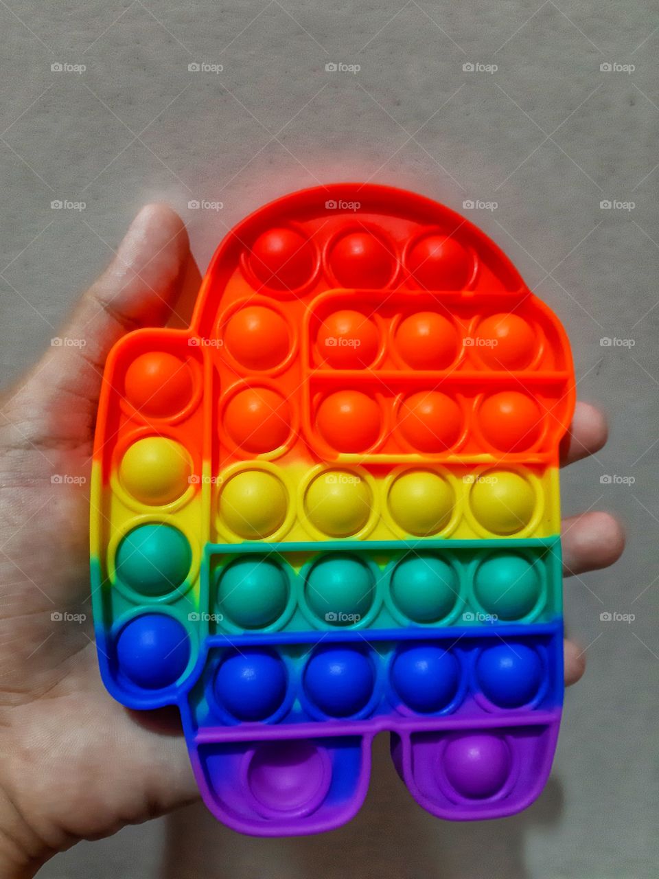 A colorful squishy rubber toy with gray background