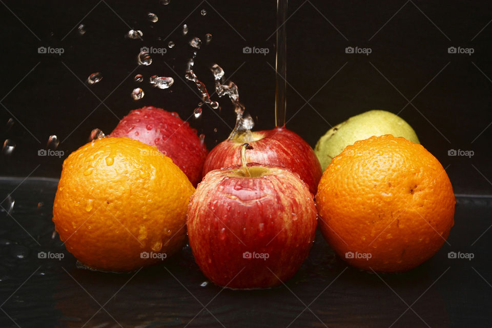 washing the fruits under to clean them - food safety