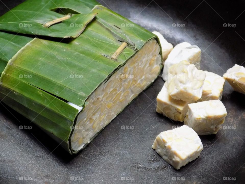 Tempe: processed from soybeans wrapped in banana leaves.