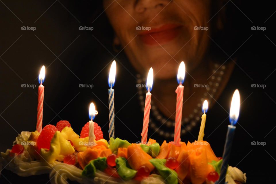 burning candles on a cake and woman night photography, happy birthday 🎂