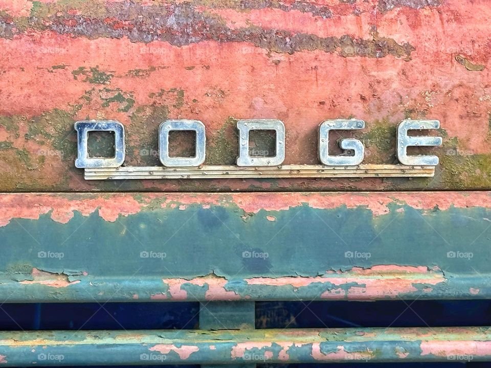 Rusted truck with DODGE decal 