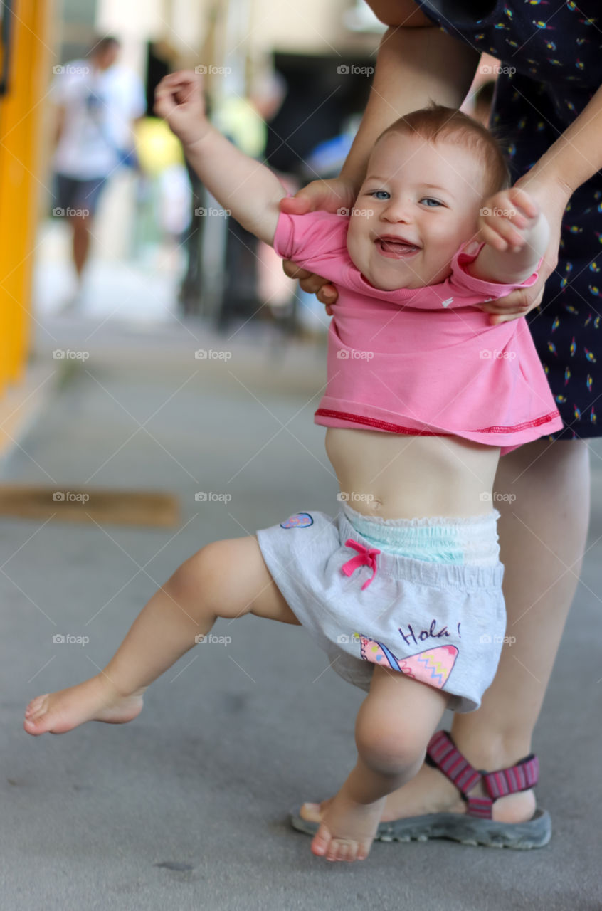 Beautiful playful baby girl in pink t-shirt