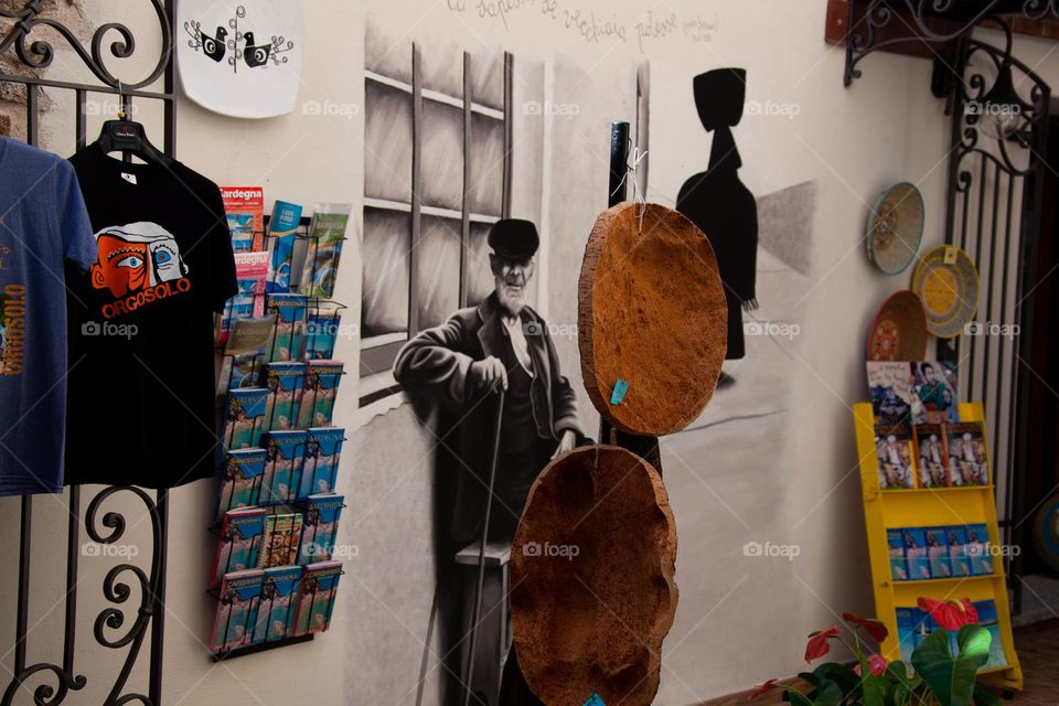 Mural artistry beside the entrance of a souvenir shop in Orgosolo - Sardinia