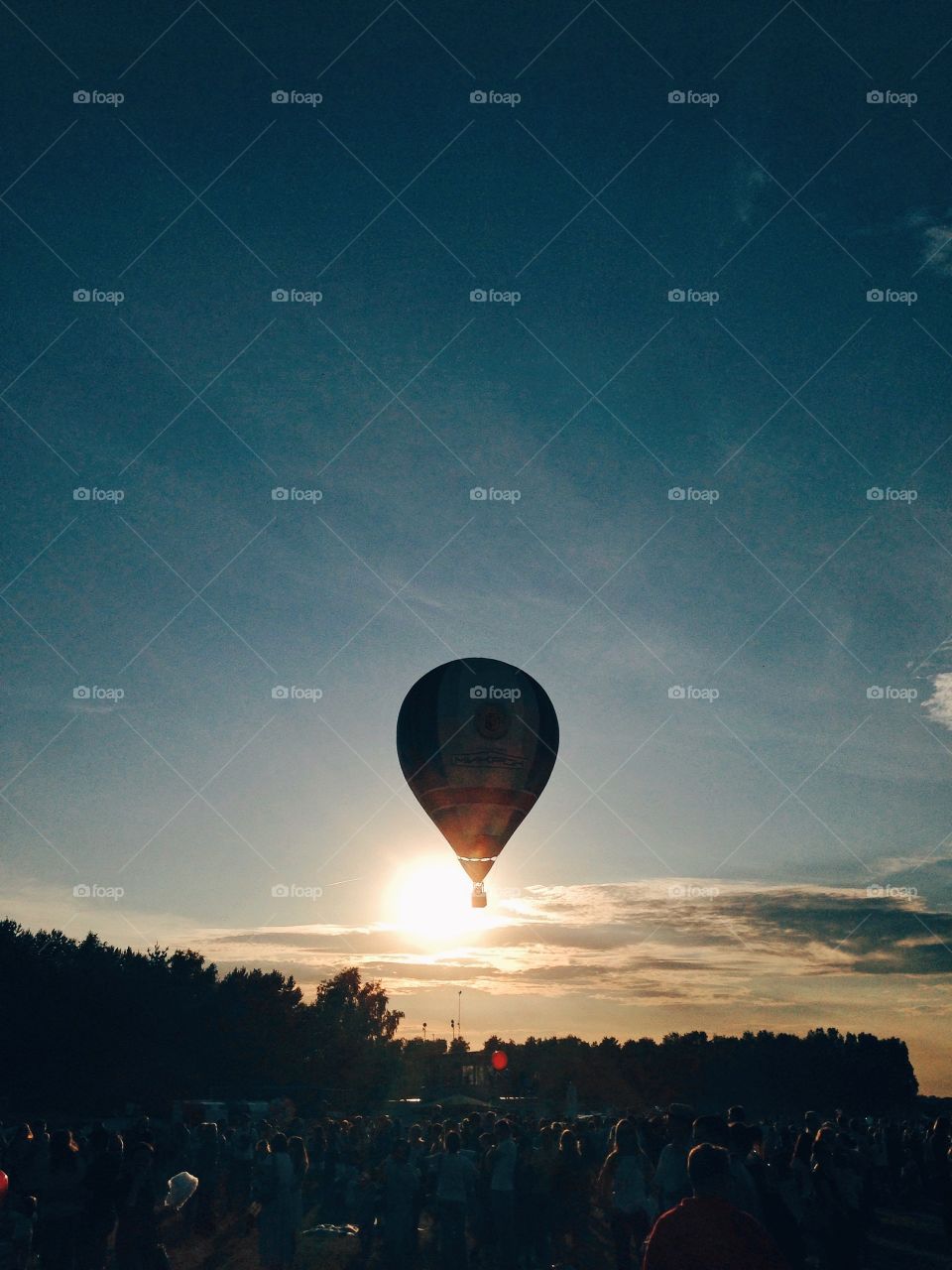 Hot air balloon flying in the sunset 