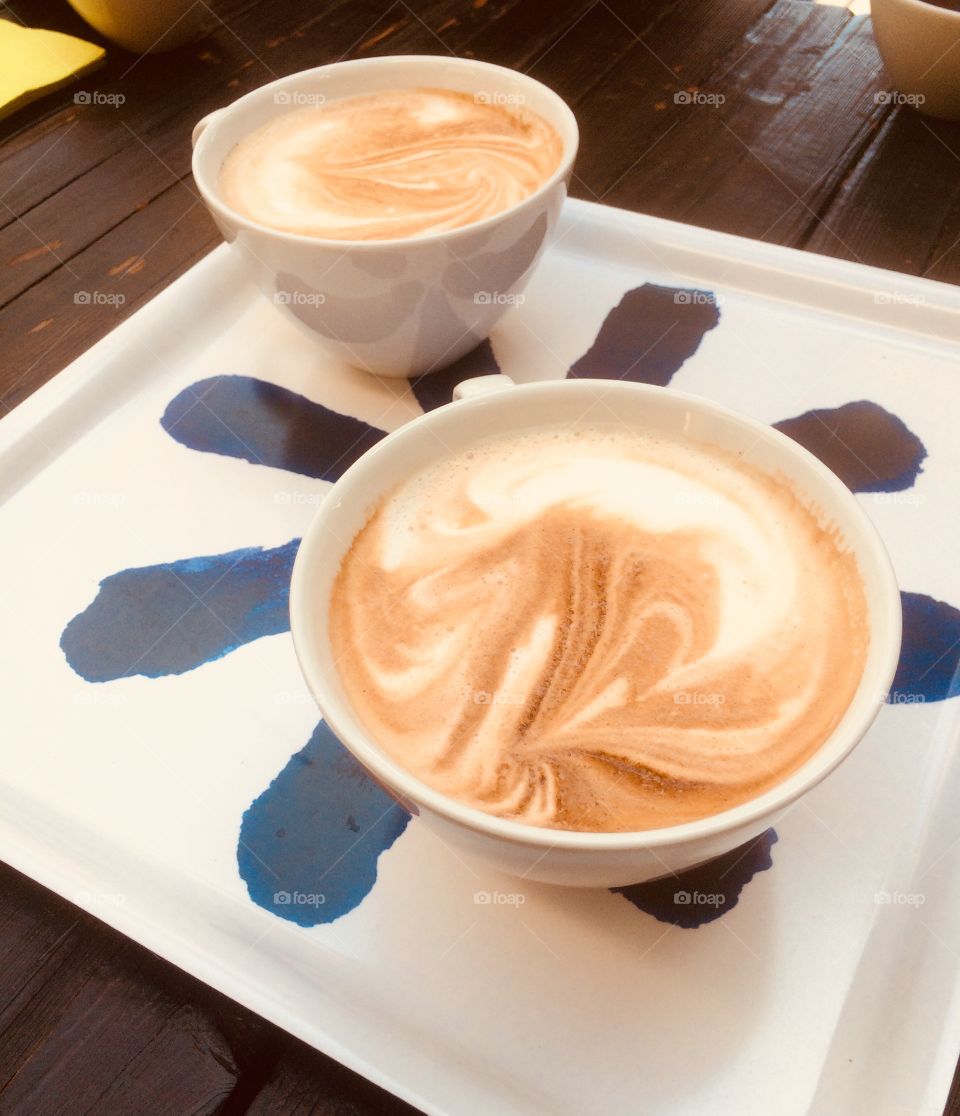 Two coffees on a tray