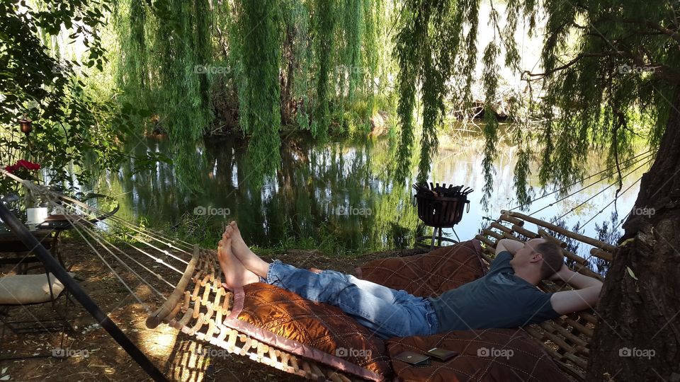 feet up, enjoying the river and listening to the birds