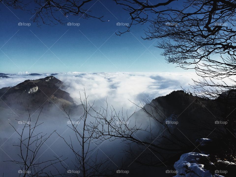 Clouds over mountain in foggy weather