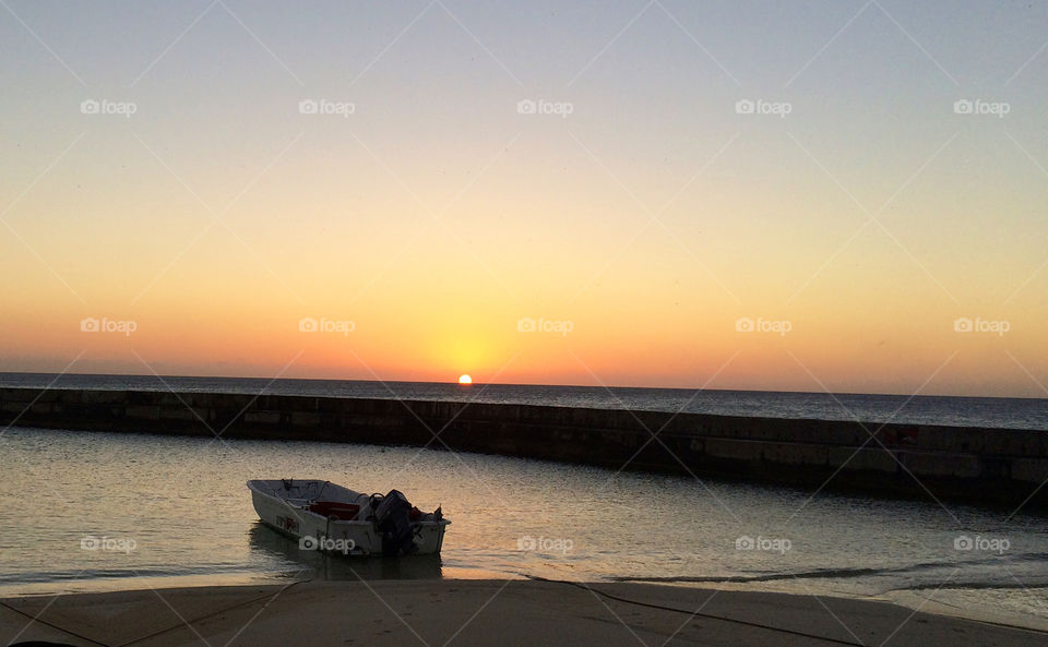 Small boat in the sunset