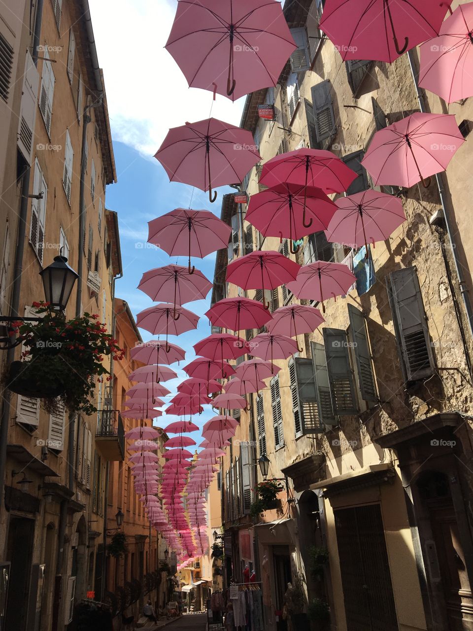 Pinky decorative umbrellas protecting from sun in historic streets