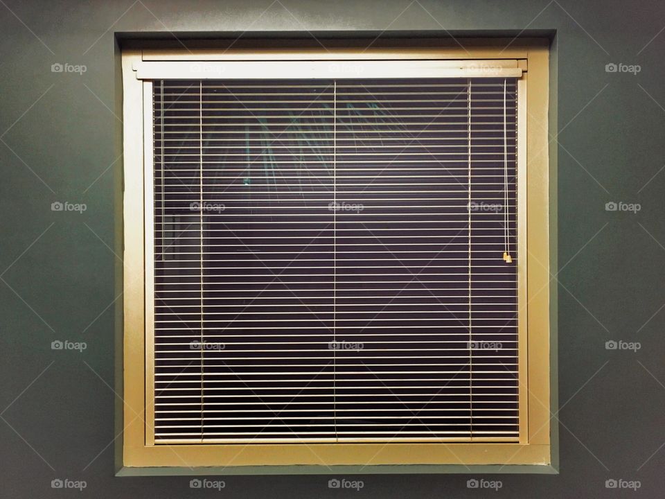 Gold painted window up against a green wall gives a building a different kind of feel. 