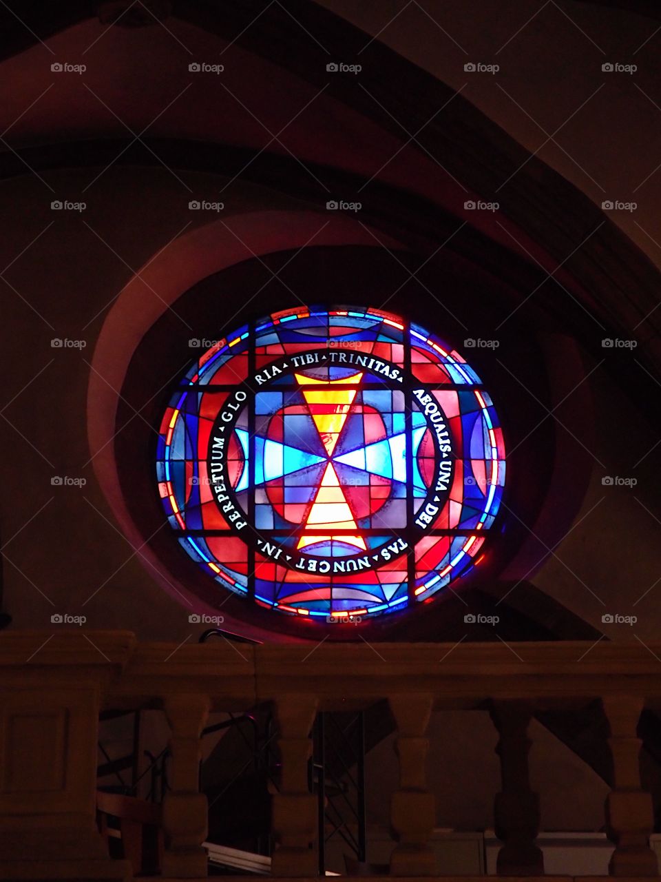 A beautiful stained glass window with vibrant colors in an old cathedral in Luxembourg. 