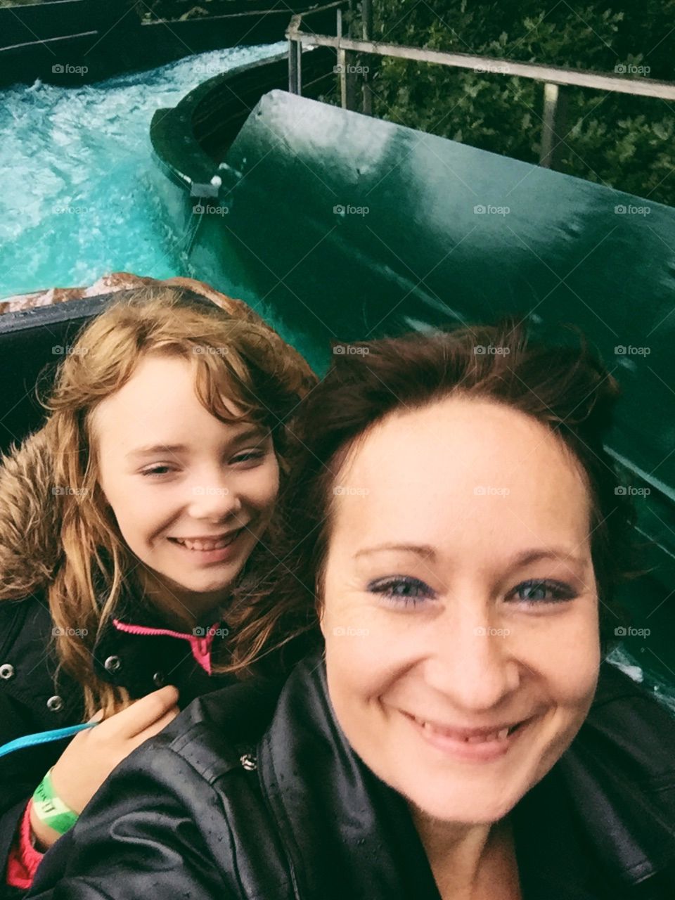 Mother an daughter riding on the amusement park ride