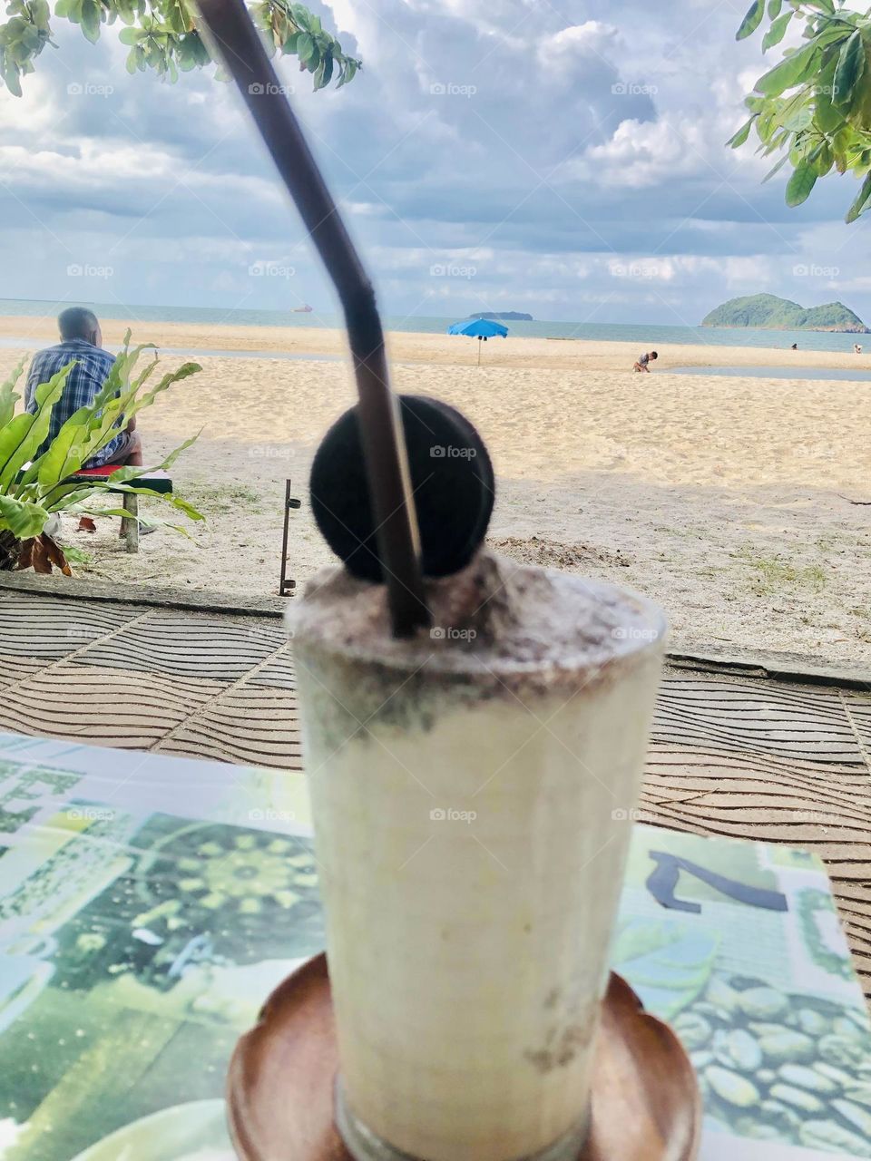 Chilling at the beach .Eating cold drink in summer vacation.
