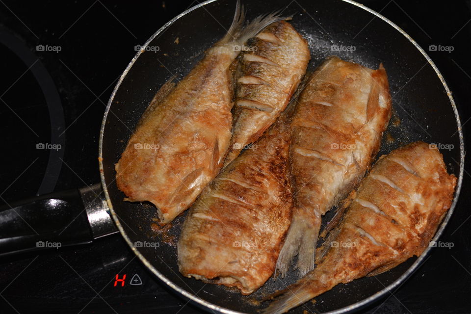 fried fish on a pan homemade cooking