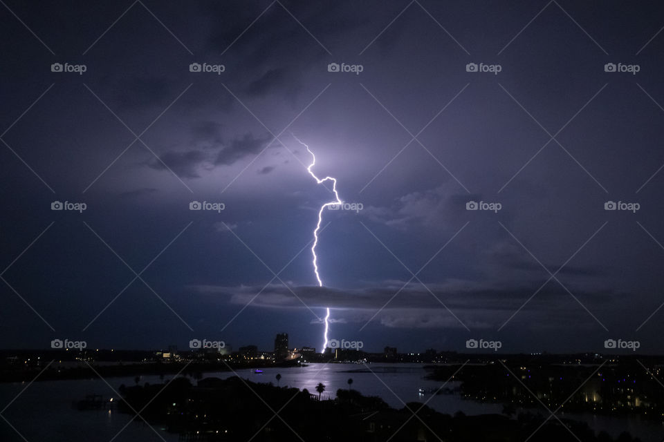 Lightning strike at night brightens up the sky 