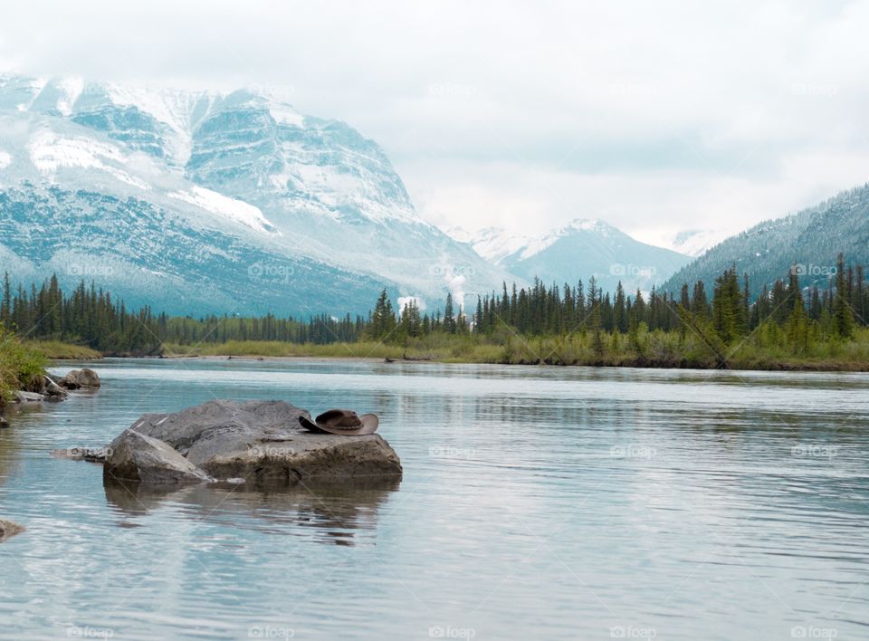 Winding glacial river with Ricky mountain backdrop Canadian scenery 