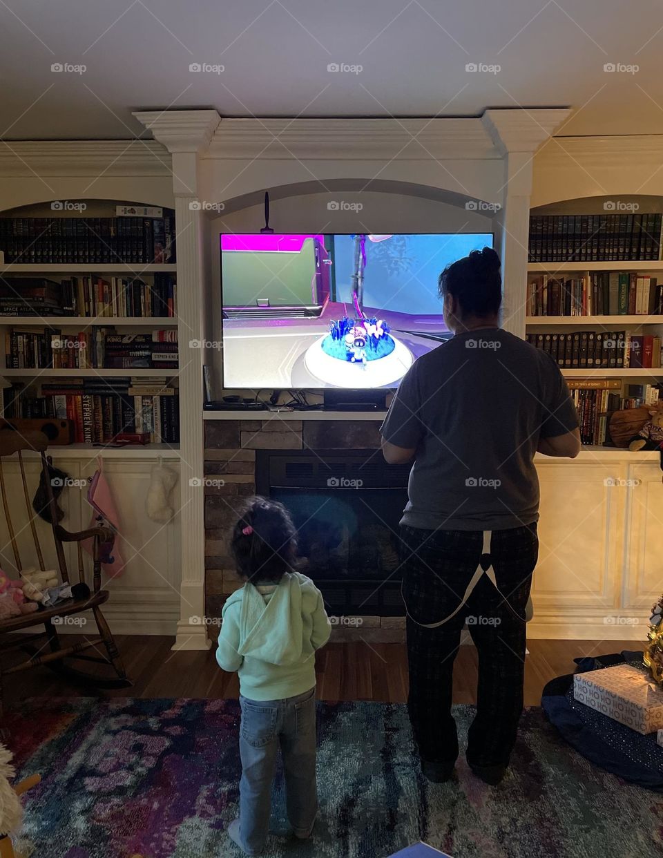 Mother and daughter watching TV together, movie watching with family, standing and watching a movie, like mother like daughter, cute family time activities