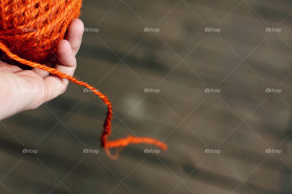 Close-up of a person hand holding rope ball