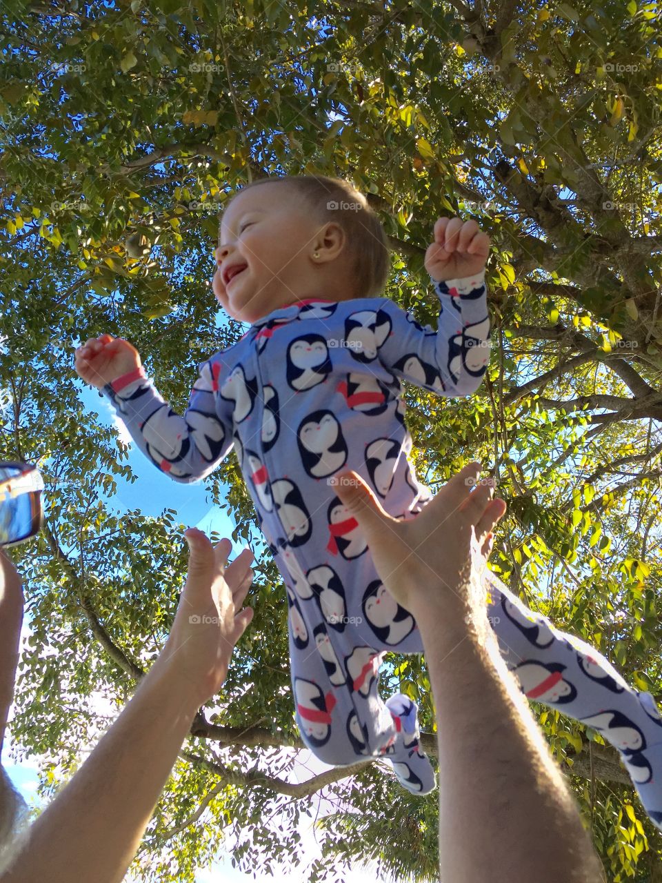 Human hand playing with baby in park