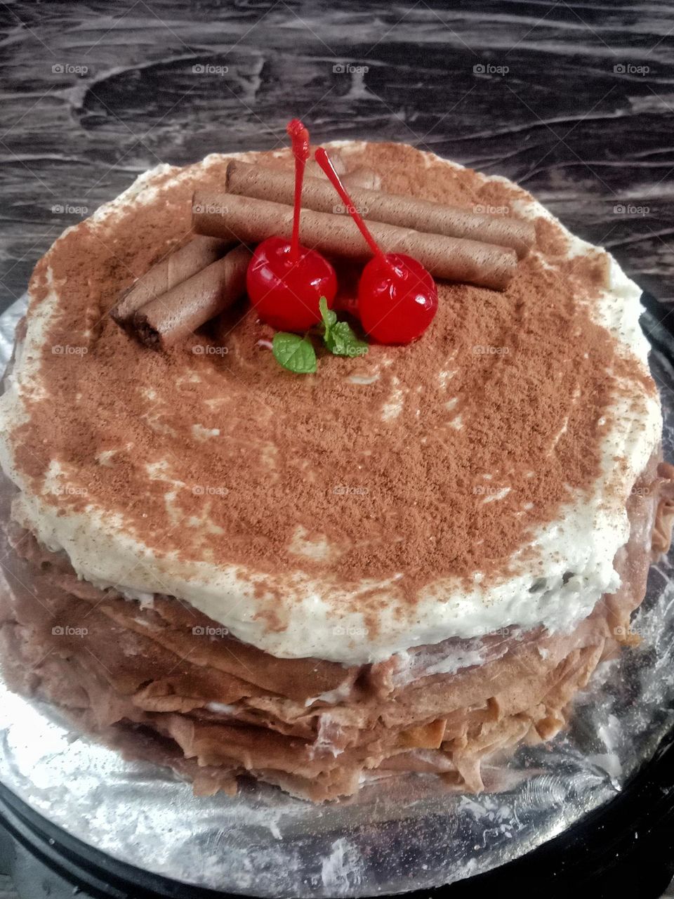Delicious chocolate cake topped with cherries.