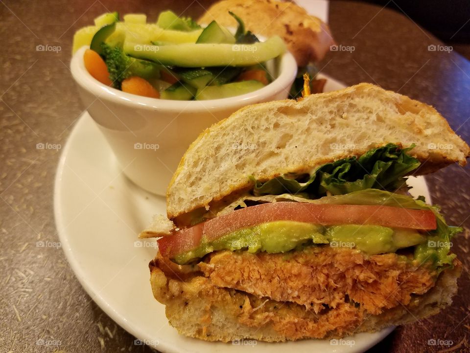 Delicious sandwich with salmon, guacamole, lettuce and tomato