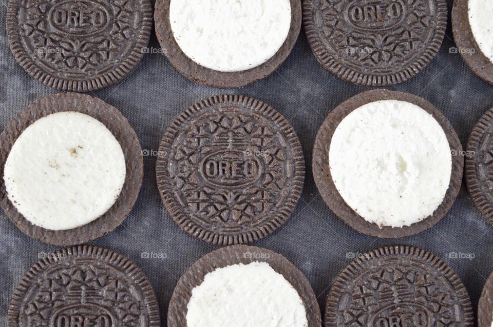 Contrasting Oreo cookies on a black background 