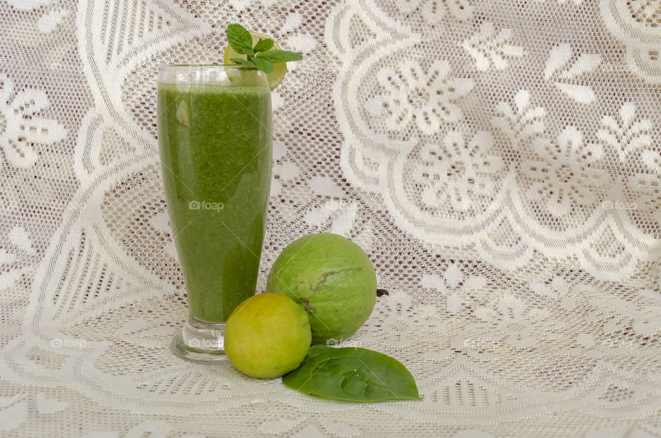 Side View Of Glass Full Of Spinach Guava Smoothie
