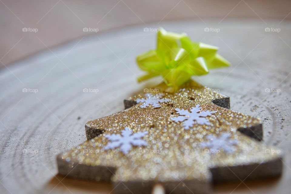 Handmade wooden Christmas tree with golden glitter.