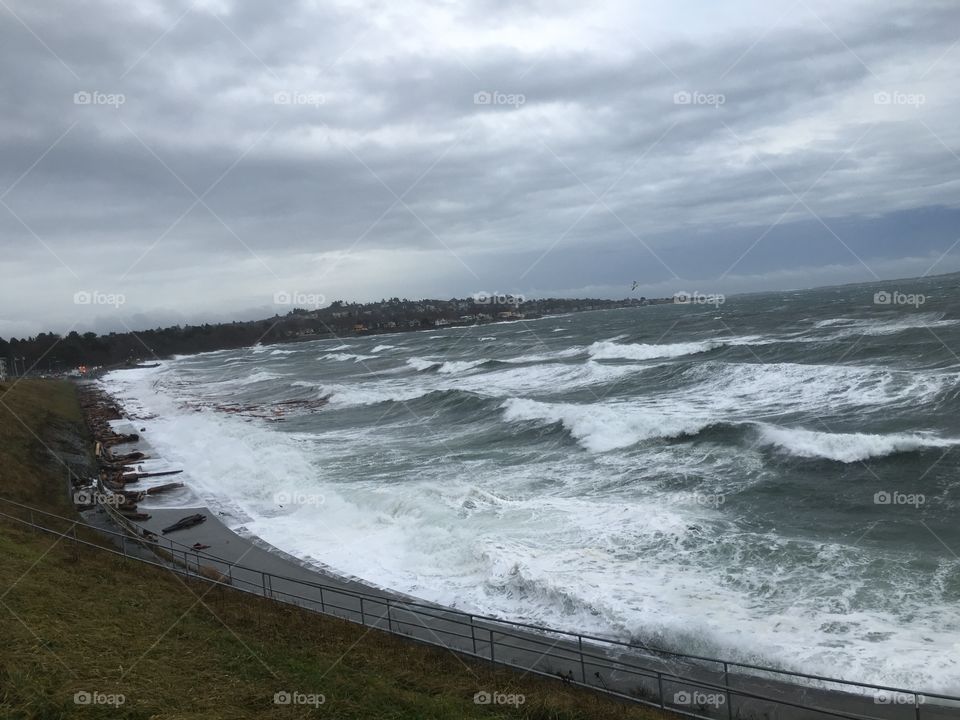 Elevated view of sea against cloudy sky