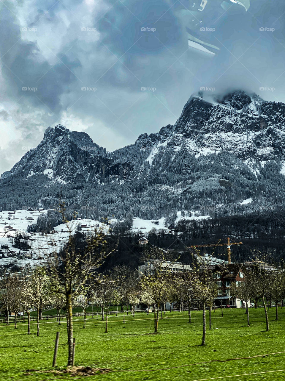Swiss beauties, Swiss mountains, clouds floating over the Alps, railway, stop, bus, beautiful painted building, road
