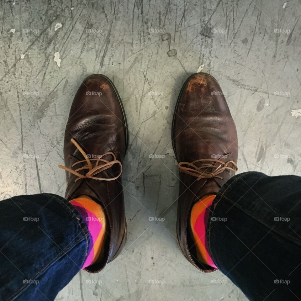 Happy socks and a well worn pair of brown boots
