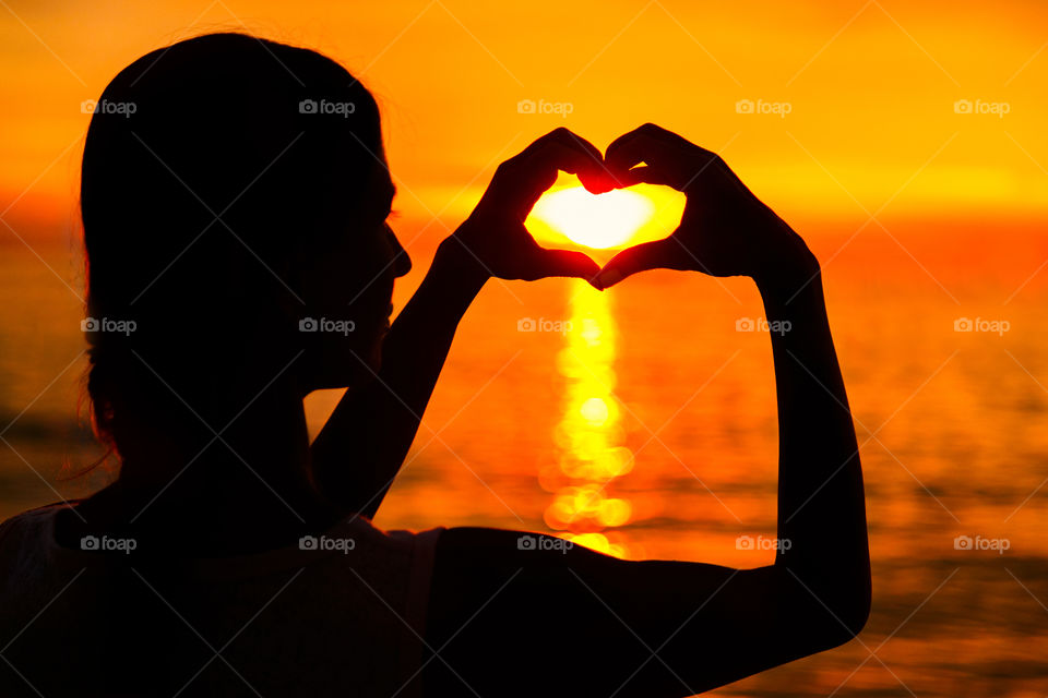 Silhouette of woman on sea