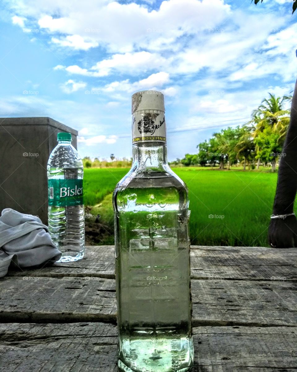 drink bottle placed in rice field #drinks #paddy #rice #tamilnadu #india #bottle #wisky #bislary