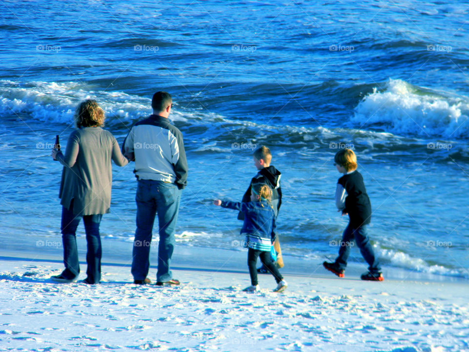 Family fun. Sibling playing at the beach