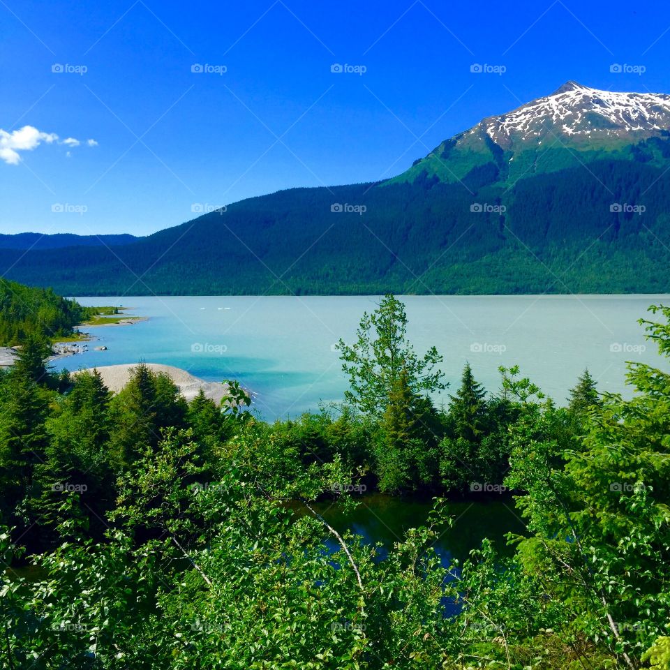 Scenic view of lake with mountain peak