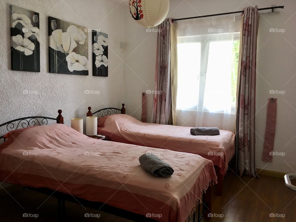 Bedroom with two singles, ready for visitors.