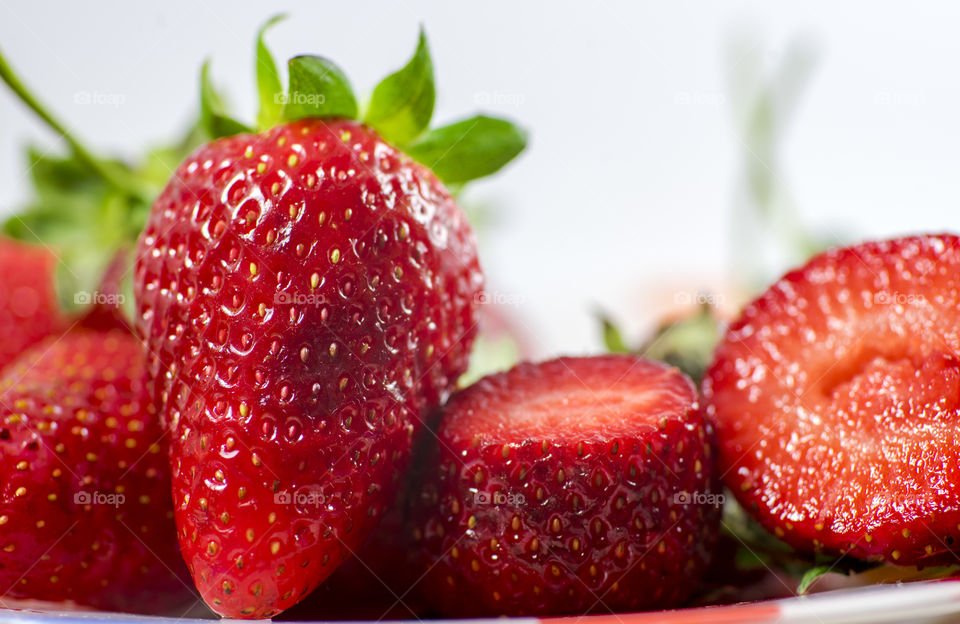 Tasty and delicious red strawberries on the plate white background brillant